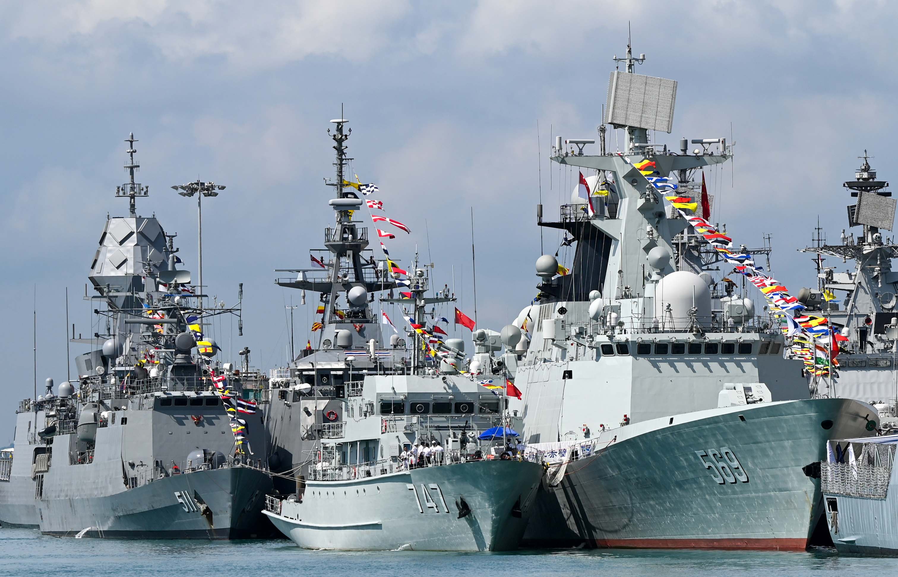 Chinese Navy missile frigate Yulin (R) and the minesweeper hunter Chibi (C) are seen docked at Changi Naval Base
